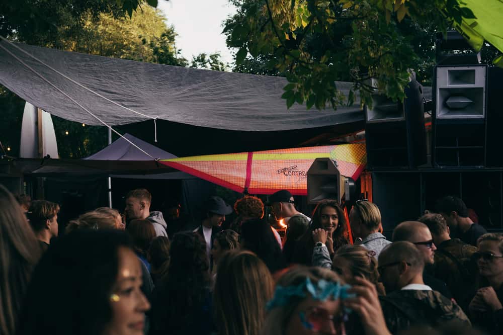 Crowd under the tarp at the cabin stage